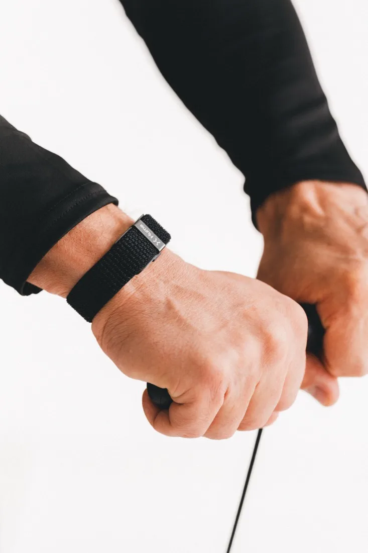 Hands gripping the analyser handles, wrist band in shot.