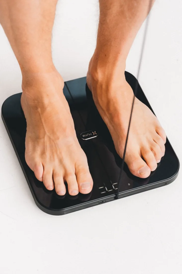 Bare feet on the body composition pod.